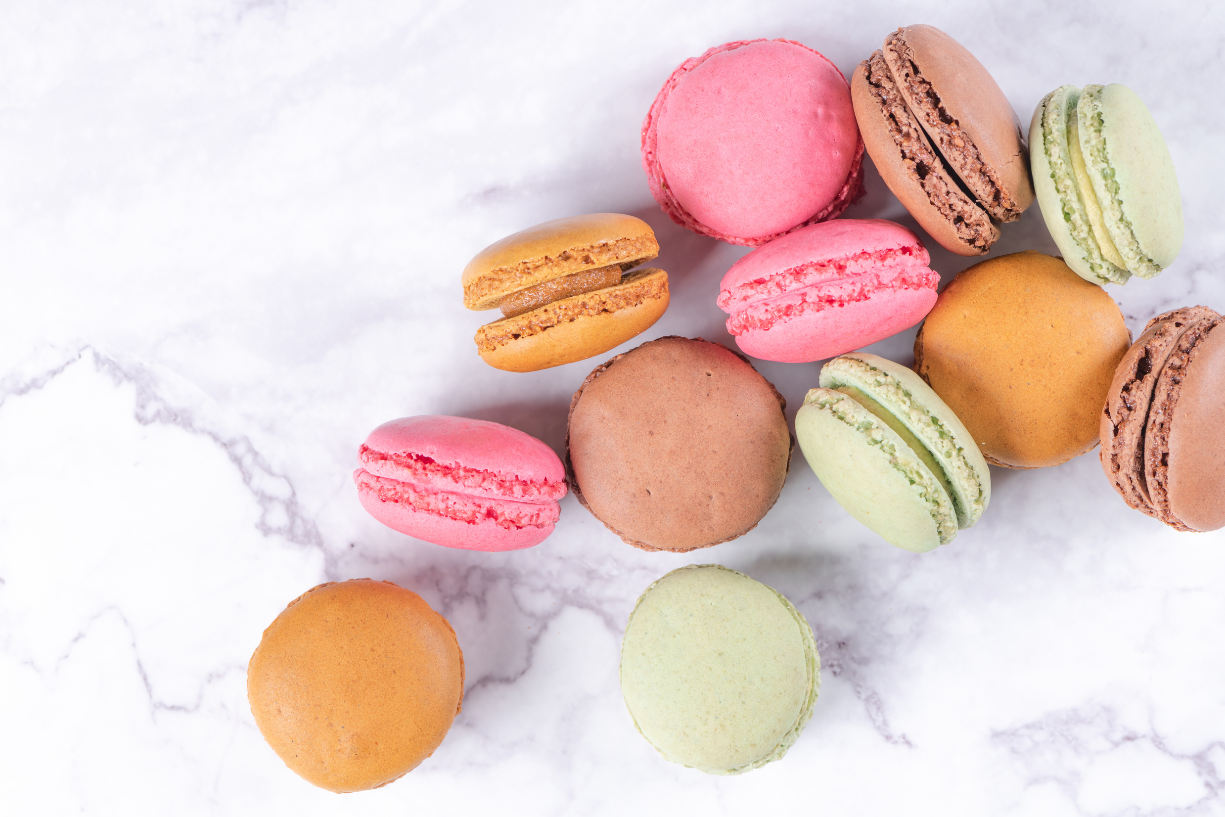 Colorful macaroons on stone table. Sweet macarons